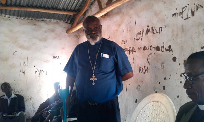 Bishop Sharing his testimony at Chabwera village Church
