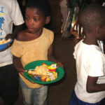 Maoni Orphanage kids in line for food