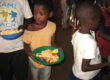 Maoni Orphanage kids in line for food